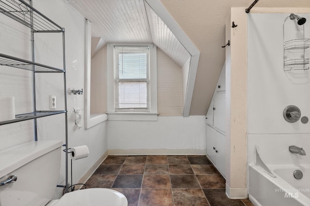 bathroom featuring shower / bathtub combination, toilet, and vaulted ceiling