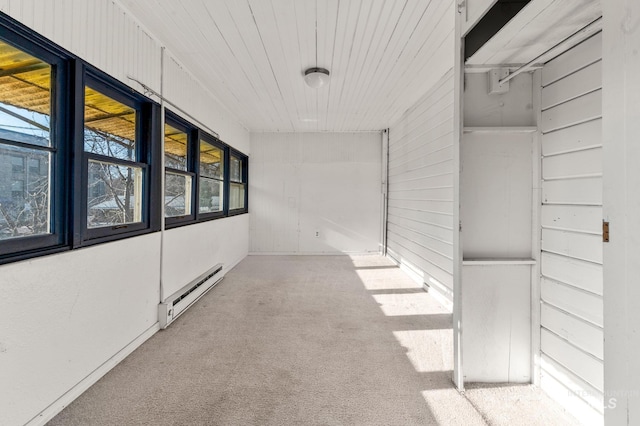 corridor with a baseboard radiator and carpet floors