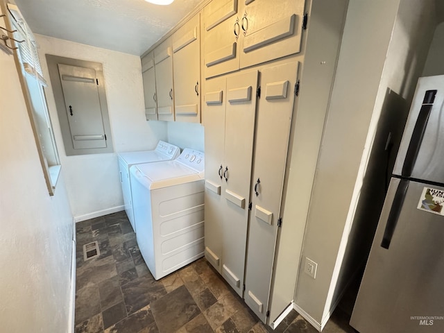 laundry room featuring cabinets and washer and dryer