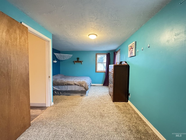 bedroom featuring carpet floors and a textured ceiling