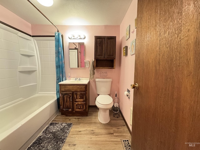 full bathroom featuring toilet, shower / bath combo with shower curtain, vanity, and hardwood / wood-style flooring