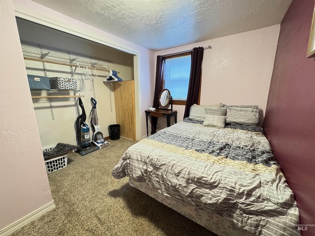 bedroom with carpet floors and a textured ceiling