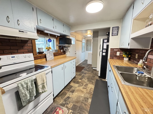 kitchen with wooden counters, white appliances, tasteful backsplash, and sink