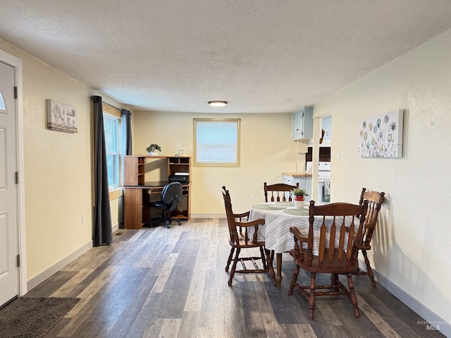 dining room featuring dark hardwood / wood-style floors and a textured ceiling