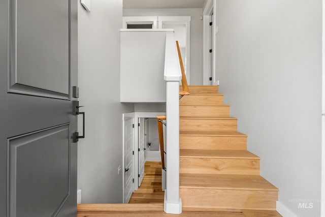 staircase featuring wood finished floors