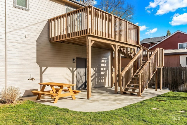 back of property featuring a patio area, stairway, fence, a deck, and a lawn