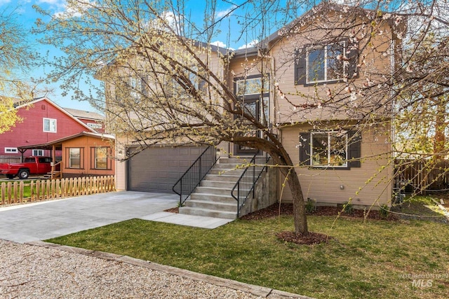 view of front of property with driveway, fence, and a front lawn