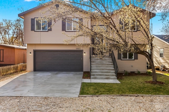 view of front of property featuring a front yard, driveway, a garage, and fence