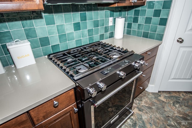 kitchen featuring range with gas cooktop and decorative backsplash