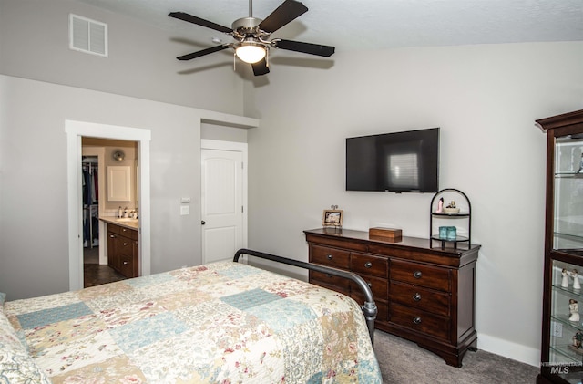 carpeted bedroom featuring ceiling fan and ensuite bathroom