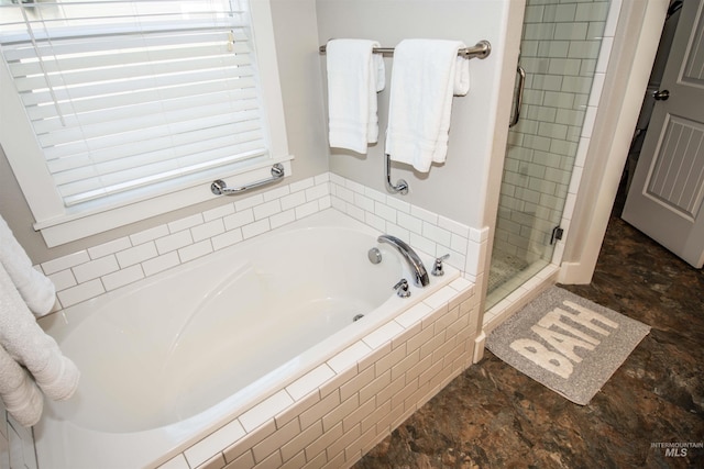 bathroom featuring independent shower and bath