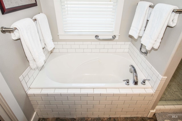 bathroom with tiled tub