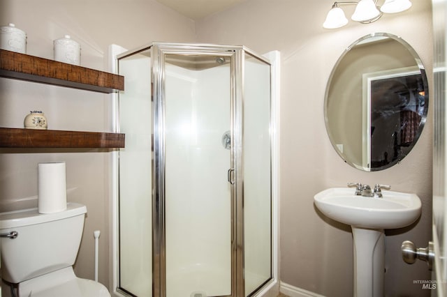 bathroom with an enclosed shower and toilet