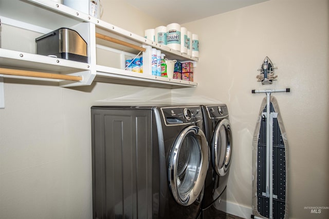 clothes washing area featuring washer and dryer