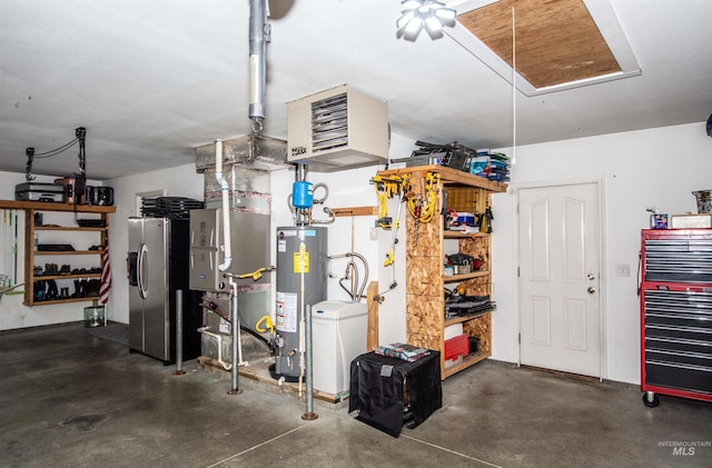 garage with gas water heater and stainless steel refrigerator with ice dispenser