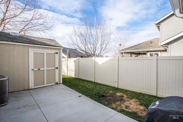 view of yard featuring a patio, cooling unit, and a storage shed