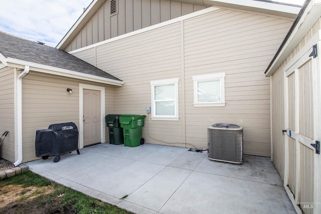 rear view of property with a patio area and central AC