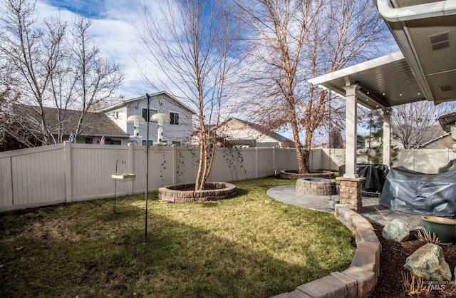 view of yard featuring an outdoor fire pit and a patio area