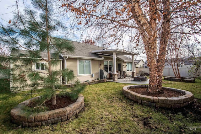 rear view of house with a lawn, a patio area, and a pergola