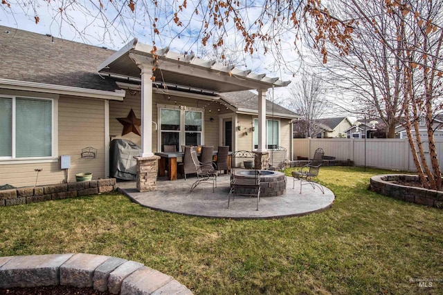 back of house with a yard, an outdoor fire pit, and a patio