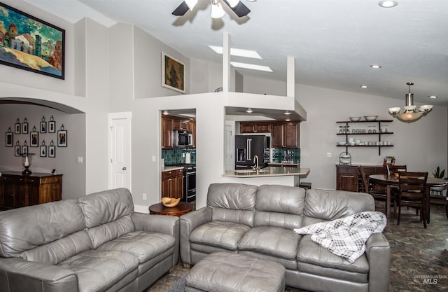 living room featuring sink, high vaulted ceiling, and ceiling fan