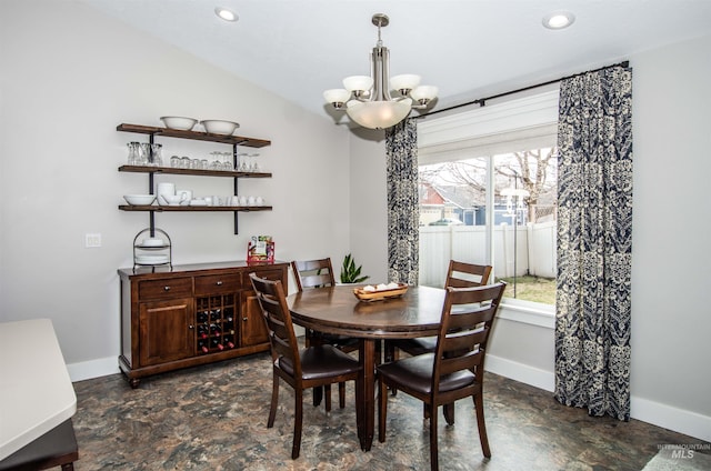 dining area with vaulted ceiling and a chandelier