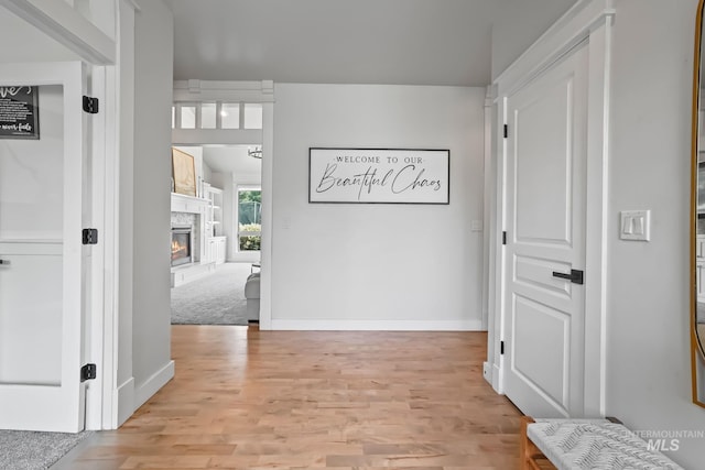 hall featuring light colored carpet