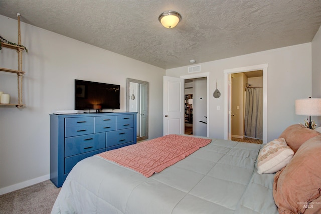 bedroom featuring visible vents, baseboards, carpet, and a textured ceiling