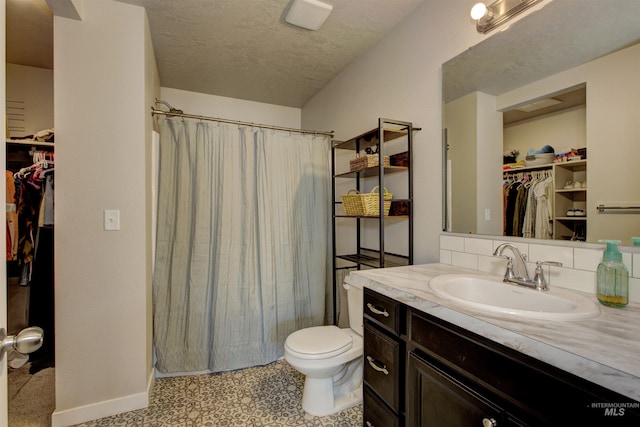 bathroom with vanity, a shower with shower curtain, toilet, and a textured ceiling