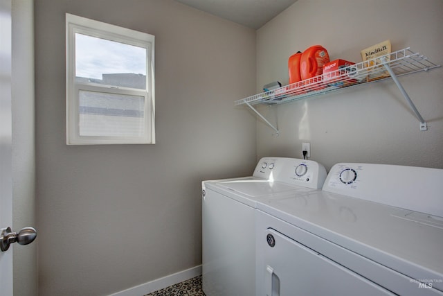 laundry area featuring laundry area, washer and dryer, and baseboards