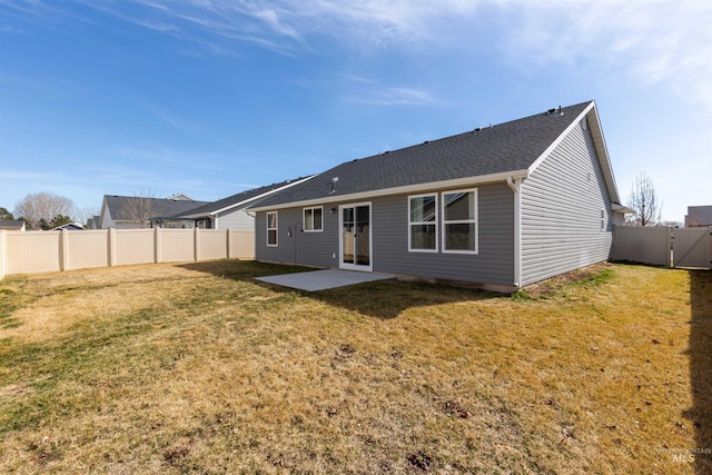 rear view of property with a yard, a fenced backyard, and a patio area