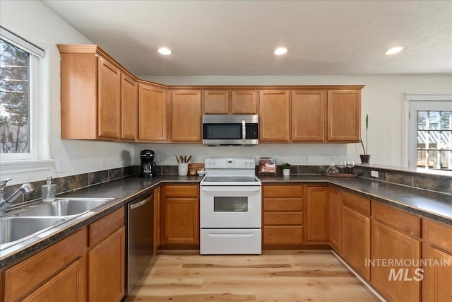 kitchen with light wood finished floors, recessed lighting, appliances with stainless steel finishes, and a sink