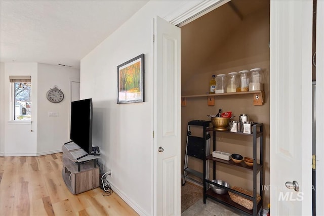 interior space featuring light wood-style flooring and baseboards