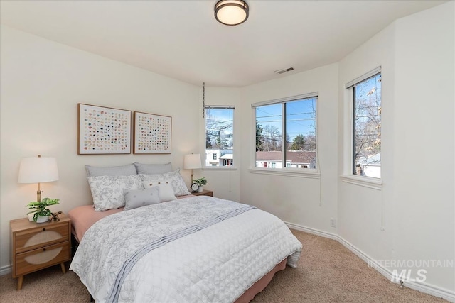 bedroom with baseboards, visible vents, and carpet floors