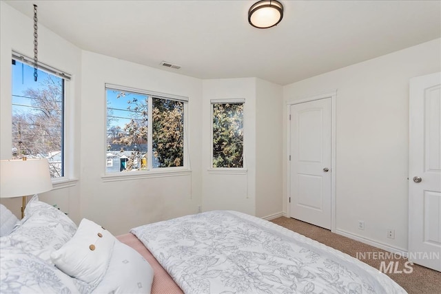 bedroom with visible vents, baseboards, and carpet floors