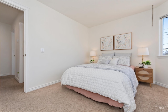 bedroom with baseboards and light carpet