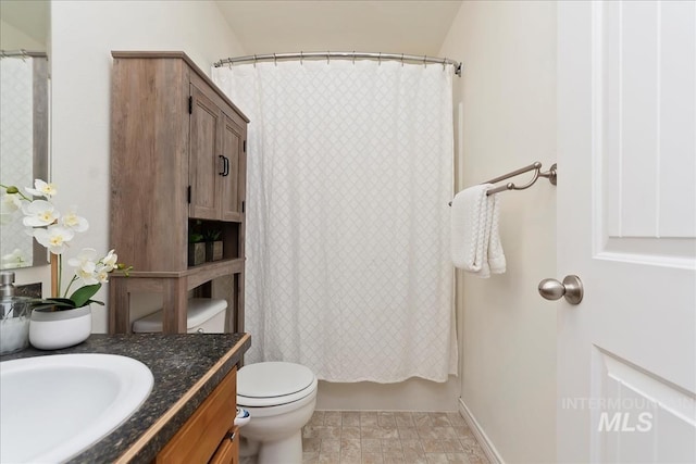 bathroom with vanity, toilet, and shower / bath combo with shower curtain