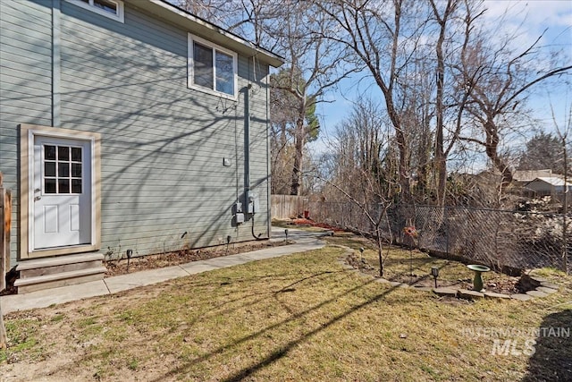 view of yard with entry steps and fence