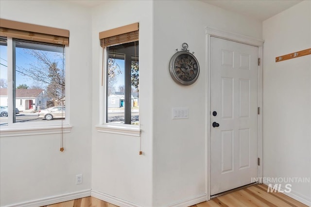 foyer with baseboards and light wood finished floors