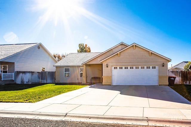 ranch-style home with a garage and a front yard