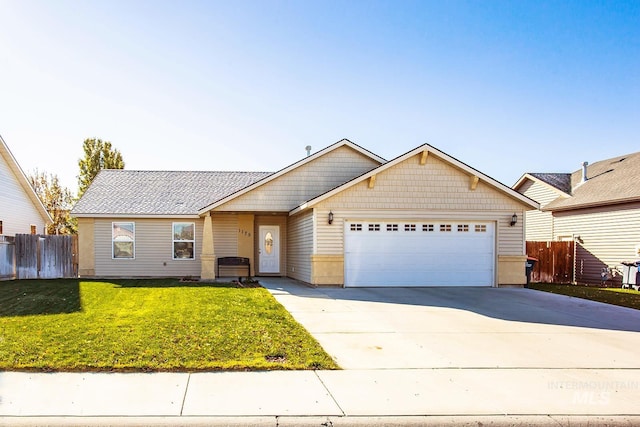 view of front of property featuring a garage and a front lawn