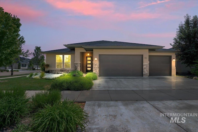 92 S Wildgrass Way, Star, ID 83669 - prairie-style home featuring an attached garage, stone siding, concrete driveway, and stucco siding