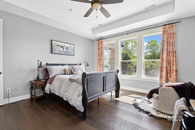 92 S Wildgrass Way, Star, ID 83669 - bedroom with baseboards, a tray ceiling, multiple windows, dark wood-style floors, and recessed lighting