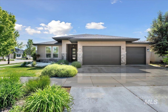 92 S Wildgrass Way, Star, ID 83669 - prairie-style house with stucco siding, an attached garage, stone siding, and driveway