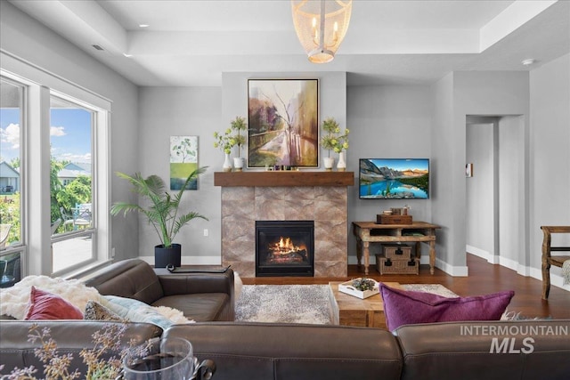 92 S Wildgrass Way, Star, ID 83669 - living room featuring a raised ceiling, wood finished floors, and plenty of natural light