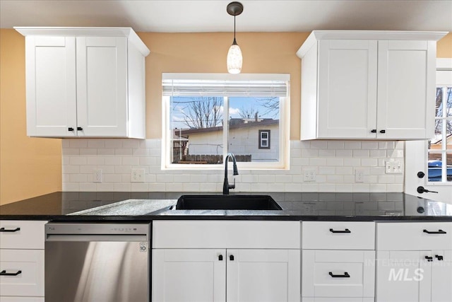 kitchen featuring a sink, white cabinets, hanging light fixtures, decorative backsplash, and dishwasher