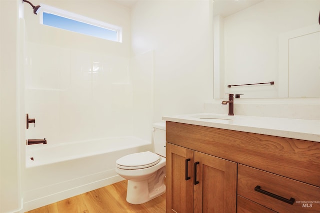 full bathroom featuring toilet, wood-type flooring, bathtub / shower combination, and vanity