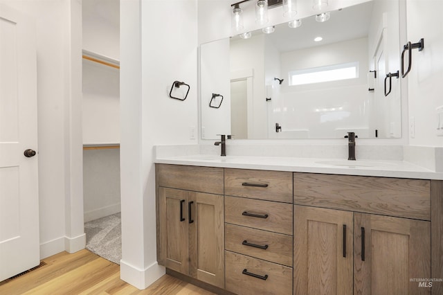 bathroom featuring vanity, hardwood / wood-style floors, and walk in shower