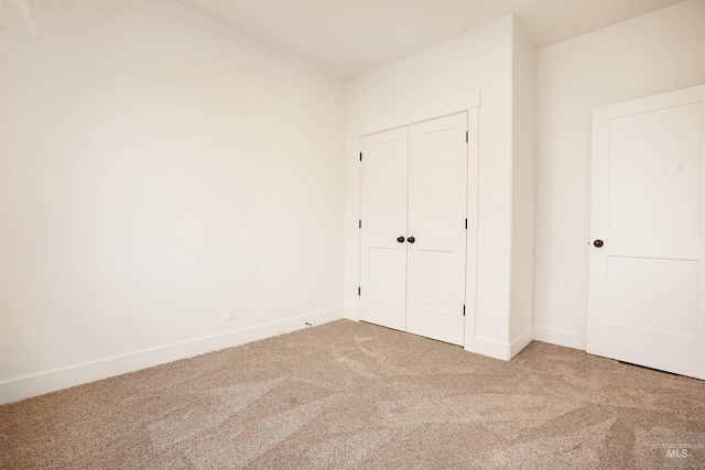 unfurnished bedroom featuring a closet and carpet