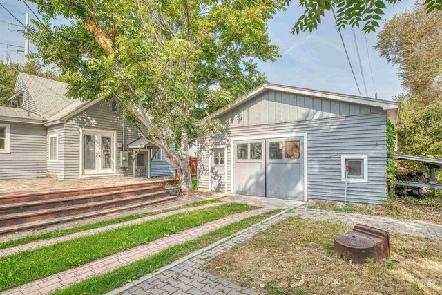 back of house with a deck and an outdoor fire pit